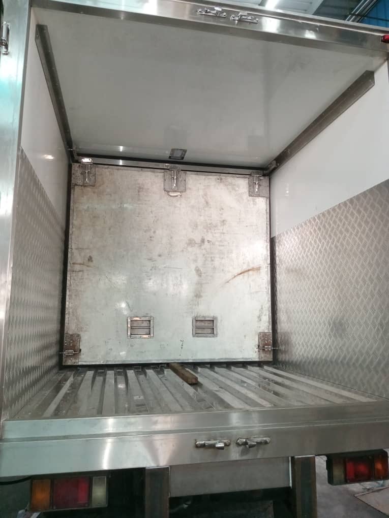 Inside an insulated body looking towards the front wall, with chequer-plate kick panels