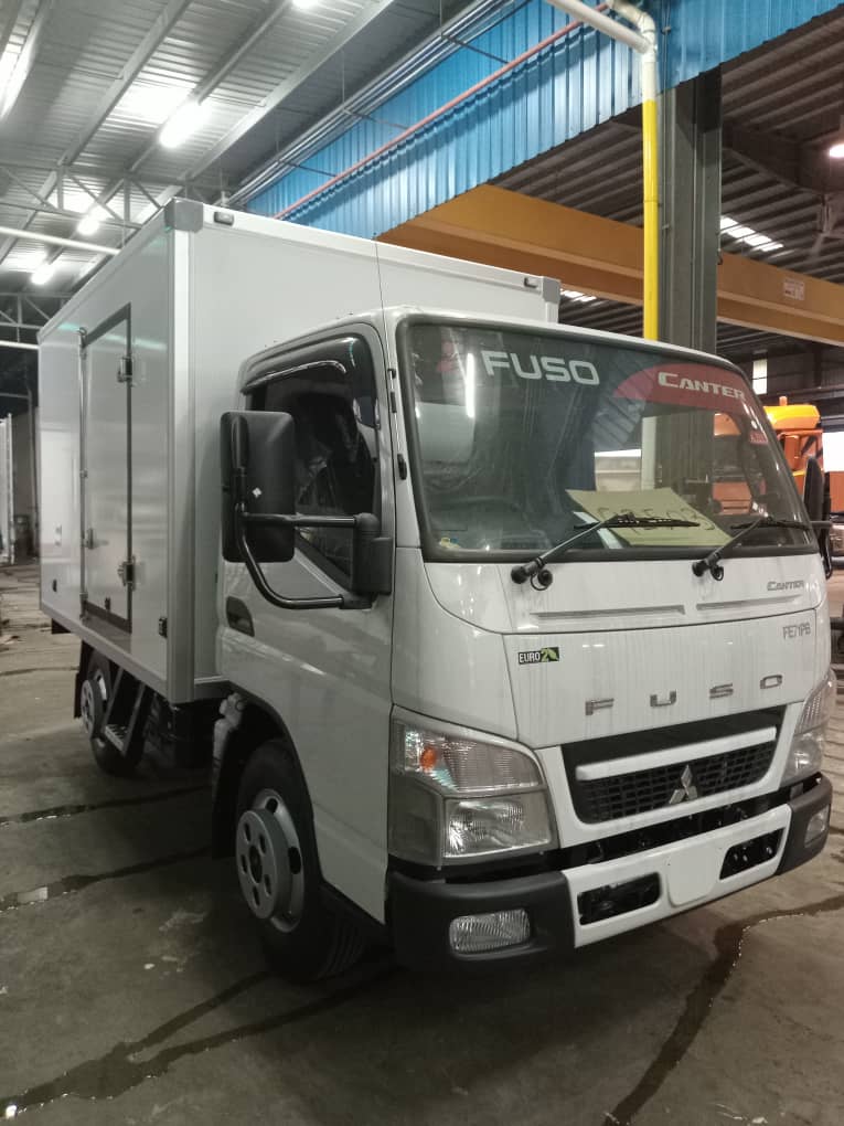 Mitsubishi Fuso Canter box truck parked in the workshop