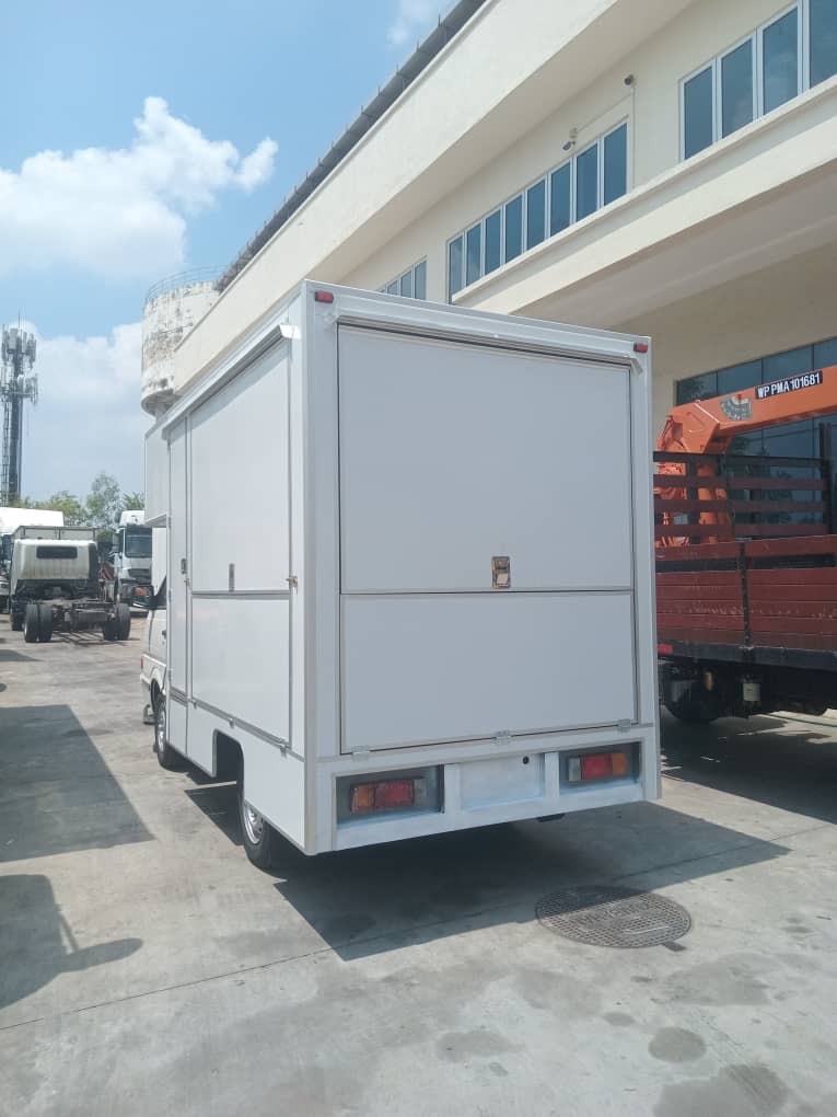 Small van with a white food box body, seen from the rear