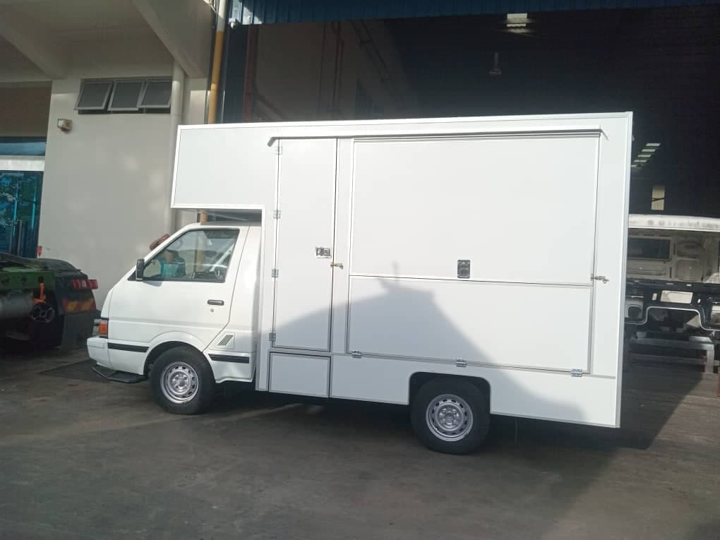 Small van fitted with a white food box body, side view