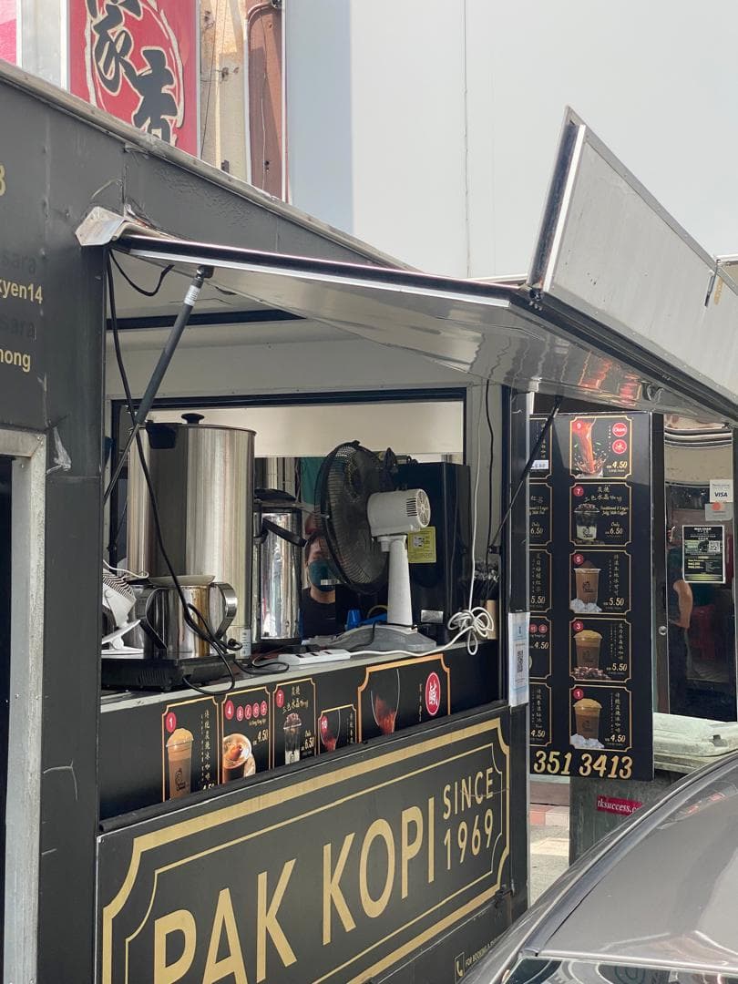 Food truck serving window with drinks equipment, a menu board and a branded counter