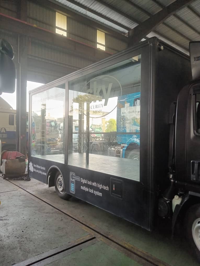 Glass-sided display body with a black wrap, seen from the side