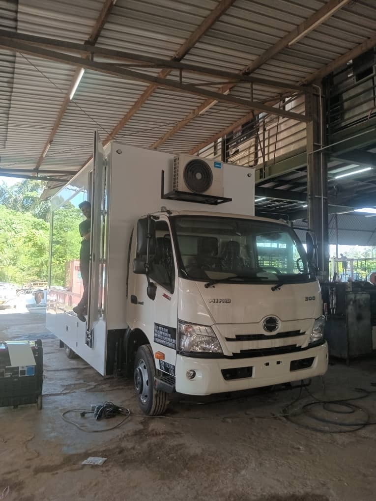 Hino truck with an open-sided box body and an air-conditioning unit