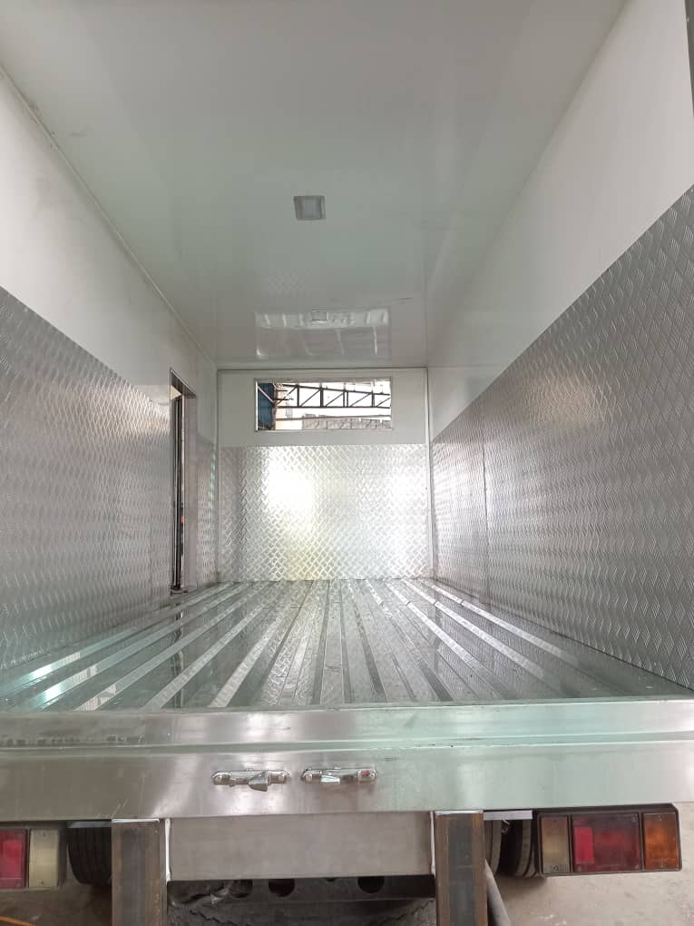 Inside an insulated body: white walls, chequer-plate lining and a ribbed aluminium floor