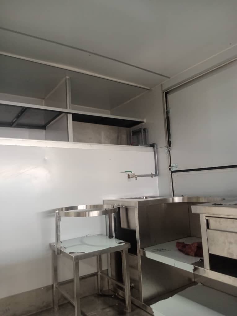 Stainless prep table, sink and shelving inside a body